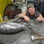 Tom working on his veining tool-. In the foreground you can see the body is taking shape